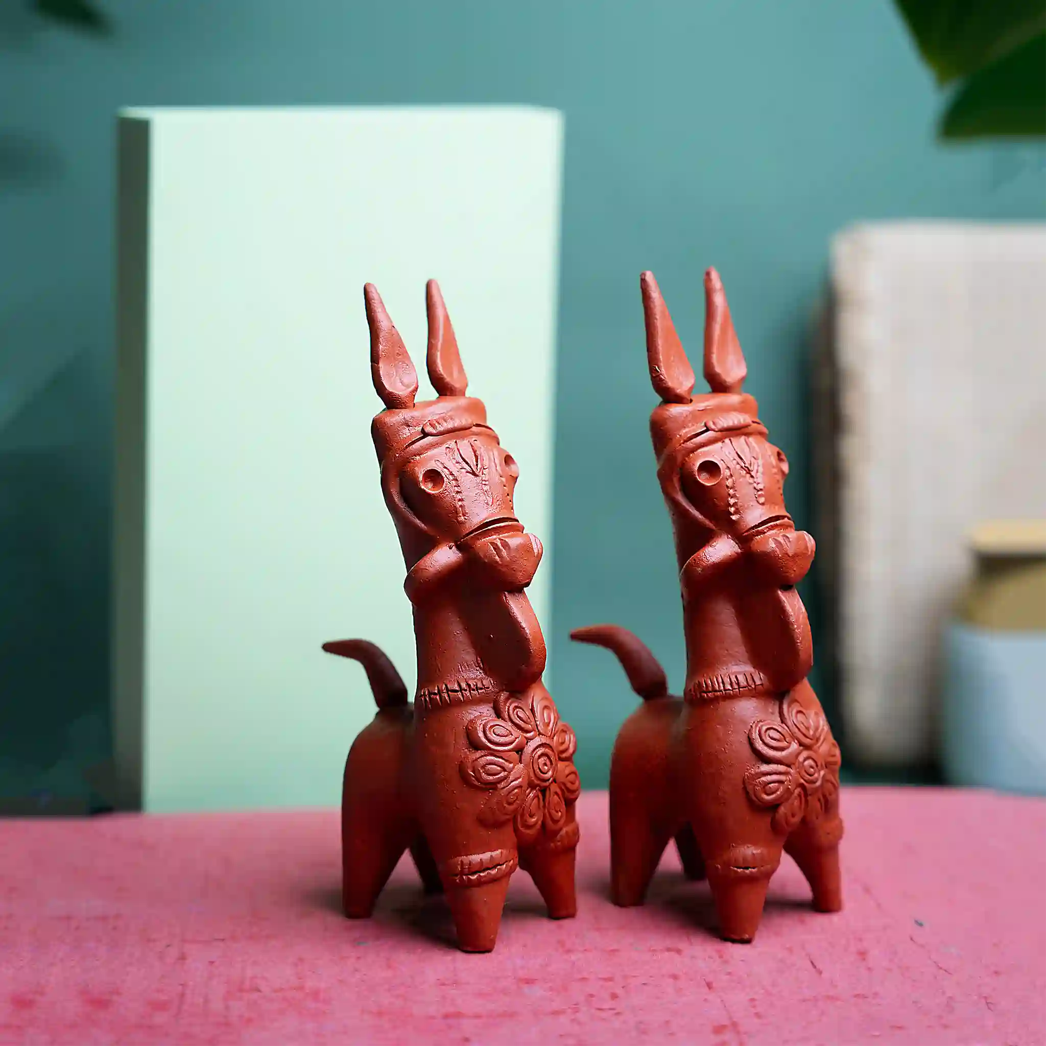 An image of a handcrafted terracotta horse, made in the Bankura district of West Bengal, India. The horses are intricately crafted and come in a variety of sizes, with 6-inch horses being the most popular.
